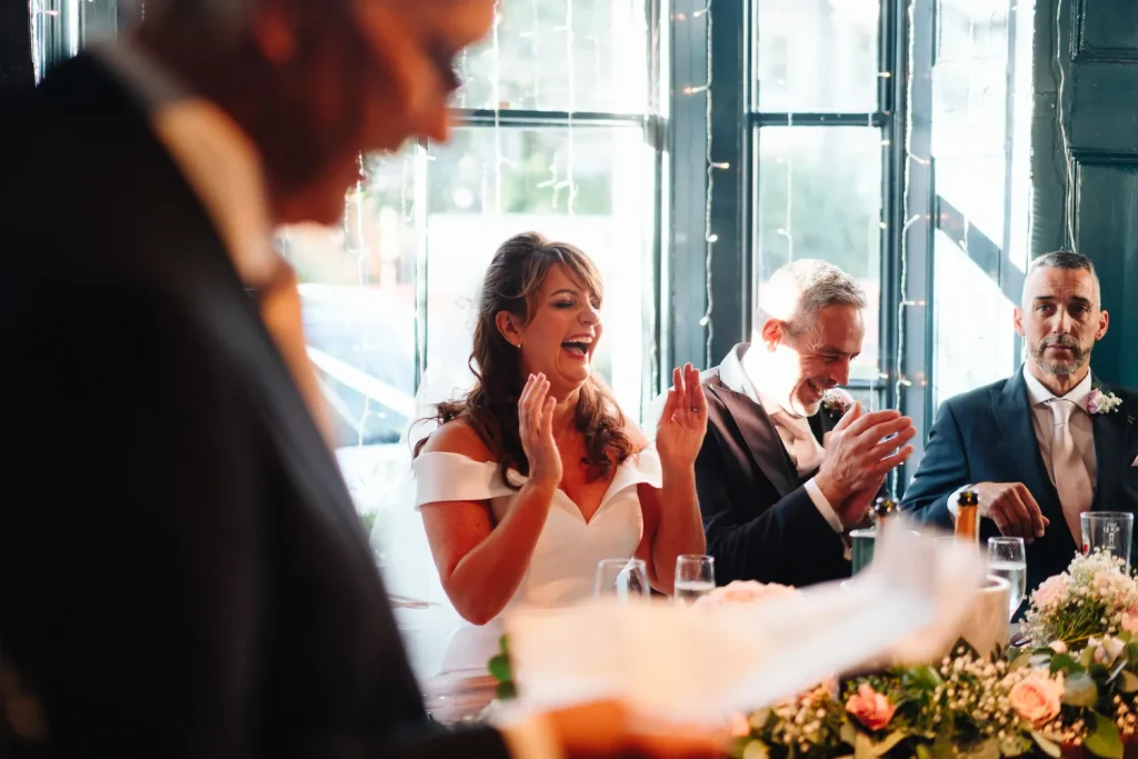 Wedding guests laughing and reacting to the speeches at The Georgian Townhouse Norwich wedding reception