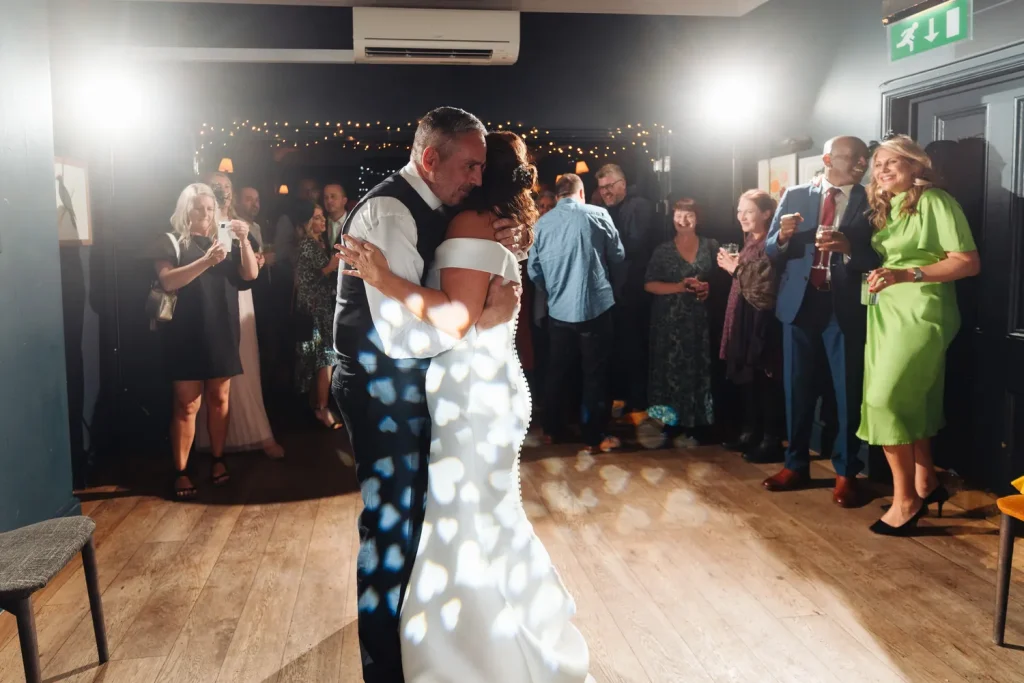 High-energy dance floor action at The Georgian Townhouse Norwich wedding evening party, guests dancing under colourful party lights