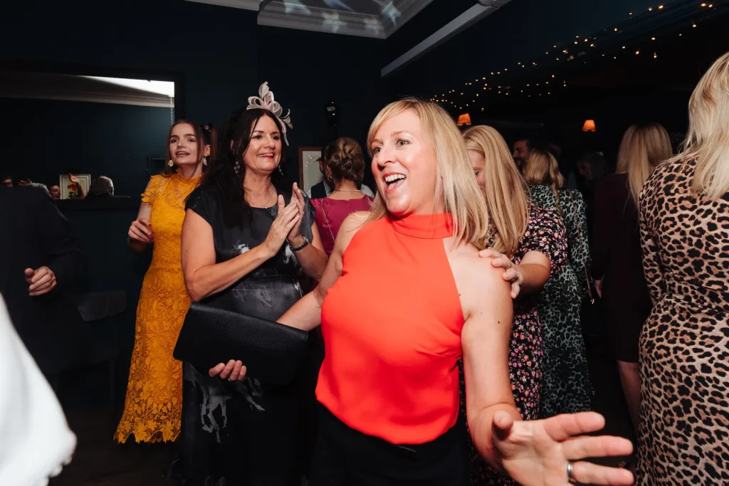 Rachel dancing with a guest at The Georgian Townhouse Norwich wedding evening reception, both laughing with pure joy on the dance floor