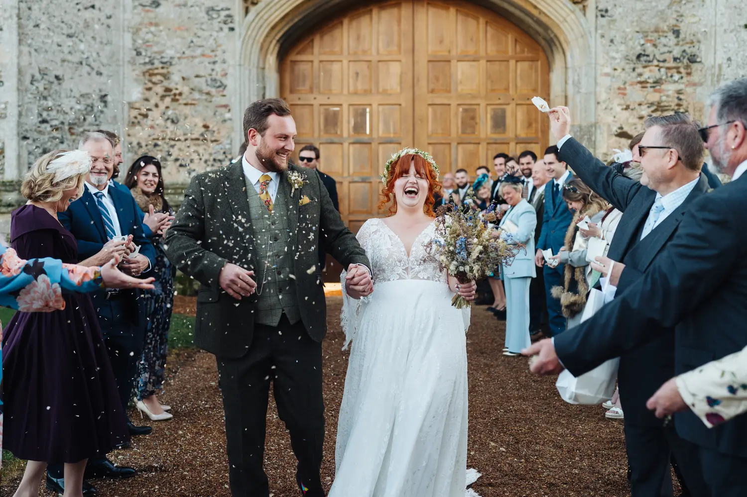 Group wedding photo of all guests gathered outside Pentney Abbey in Norfolk
