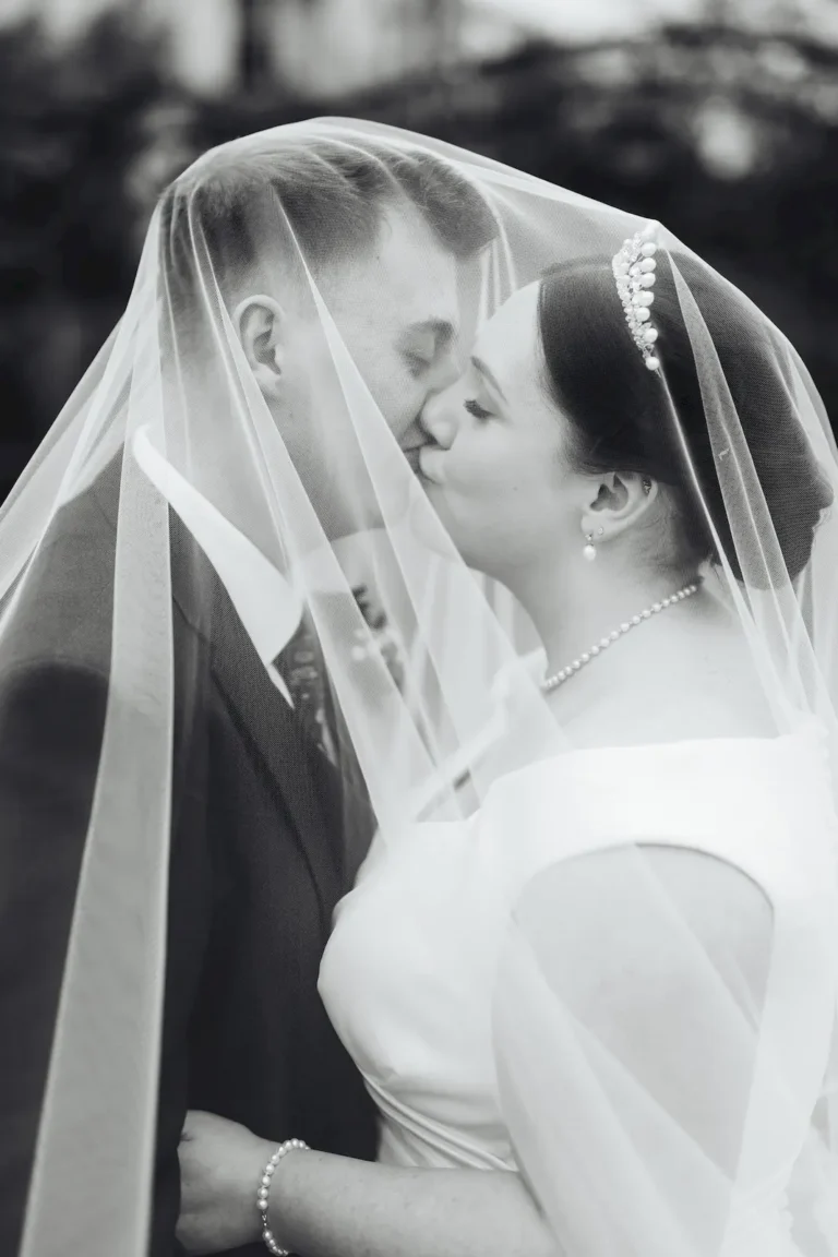 Bride and groom kissing under her veil – full day wedding photography in Norfolk