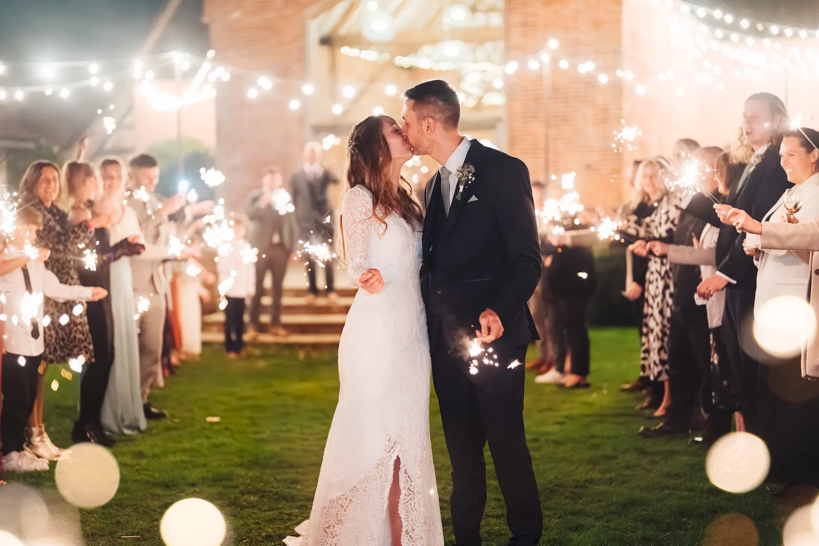 Sparklers lighting wedding reception celebration - festive moment at wedding venue