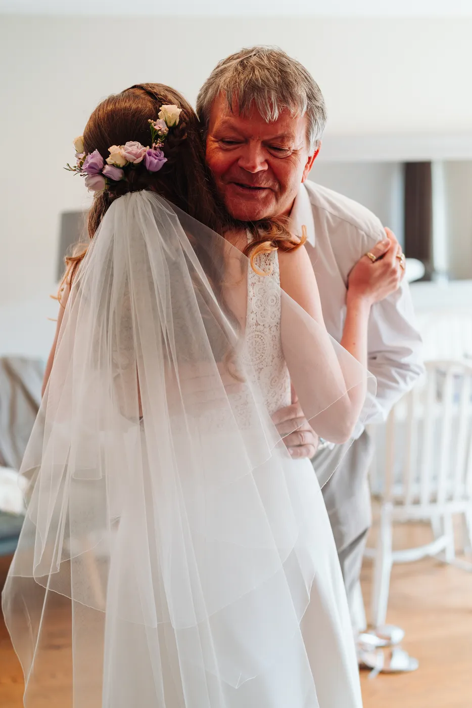 Happy couple laughing with wedding guests after the ceremony at Norfolk Mead Hotel