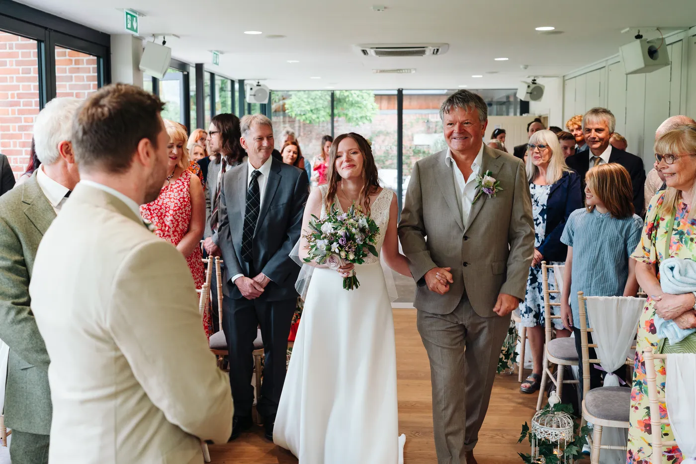 Hannah and Gareth walking back down the aisle as newlyweds at Norfolk Mead Hotel