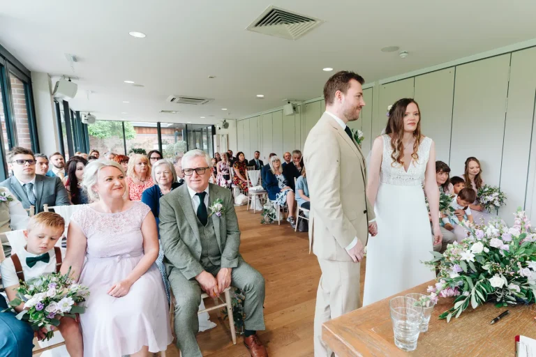 Bride and groom stepping outside after their ceremony at The Norfolk Mead Coltishall