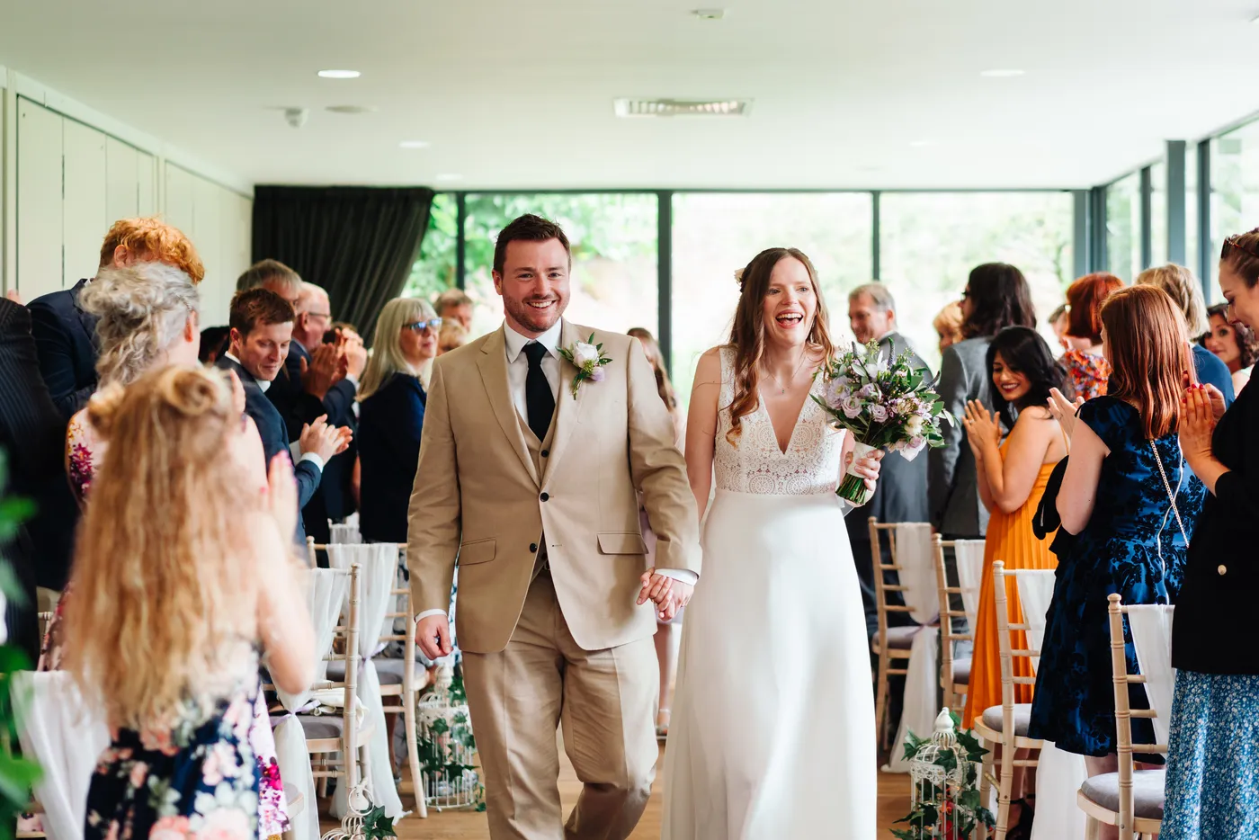 Wedding guests mingling on the lawn during drinks reception at Norfolk Mead Hotel Norfolk