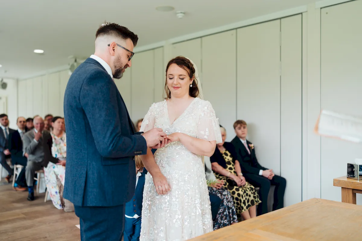 Annalie and Matt walking hand in hand in the walled garden at Norfolk Mead Coltishall