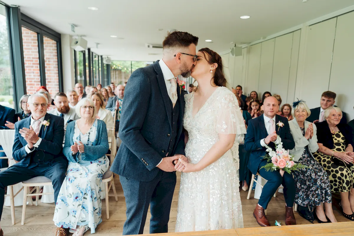 Candid wedding photograph taken in the sunny gardens of Norfolk Mead Hotel Norfolk