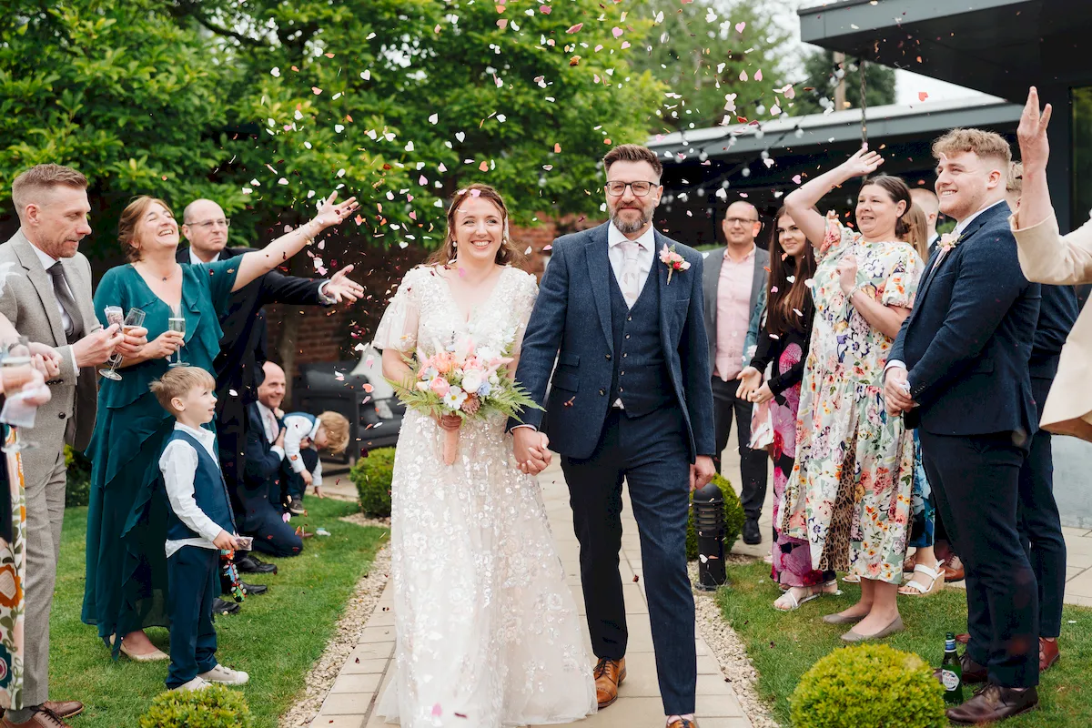 Annalie and Matt laughing together in the grounds of Norfolk Mead Hotel Coltishall