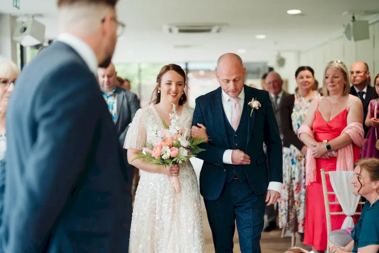 Annalie and Matt walking back down the aisle as newlyweds at Norfolk Mead Hotel