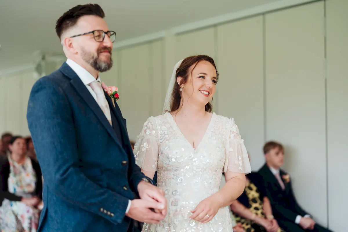 Annalie and Matt walking through confetti at The Norfolk Mead Hotel Coltishall