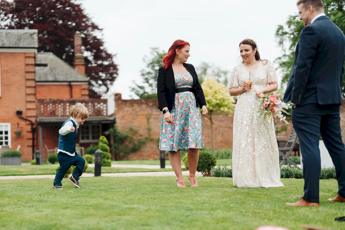 Annalie and Matt celebrating with confetti on the lawn at The Norfolk Mead Hotel