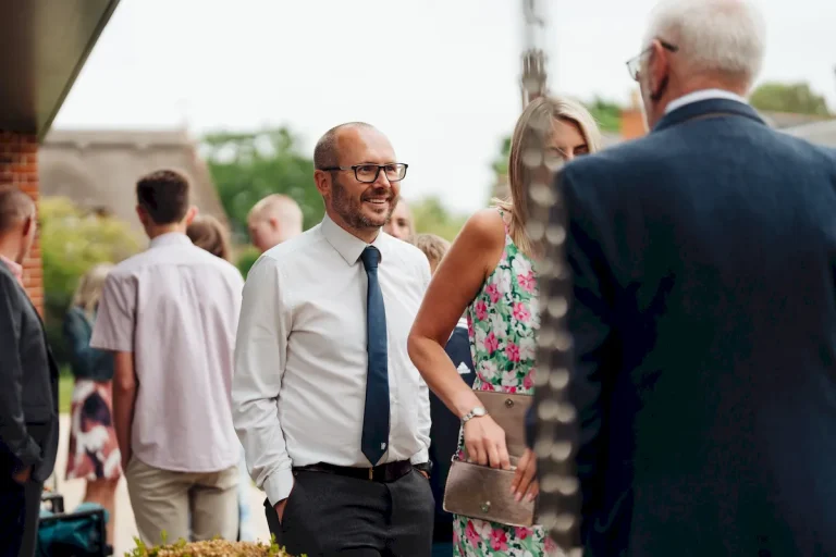 Wedding guests enjoying drinks in the walled garden at The Norfolk Mead Hotel Norfolk