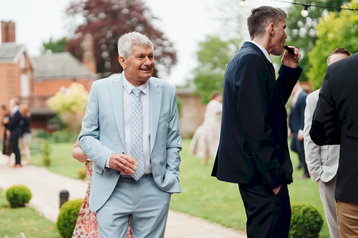 Guests mingling on the lawn during drinks reception at Norfolk Mead Hotel Coltishall