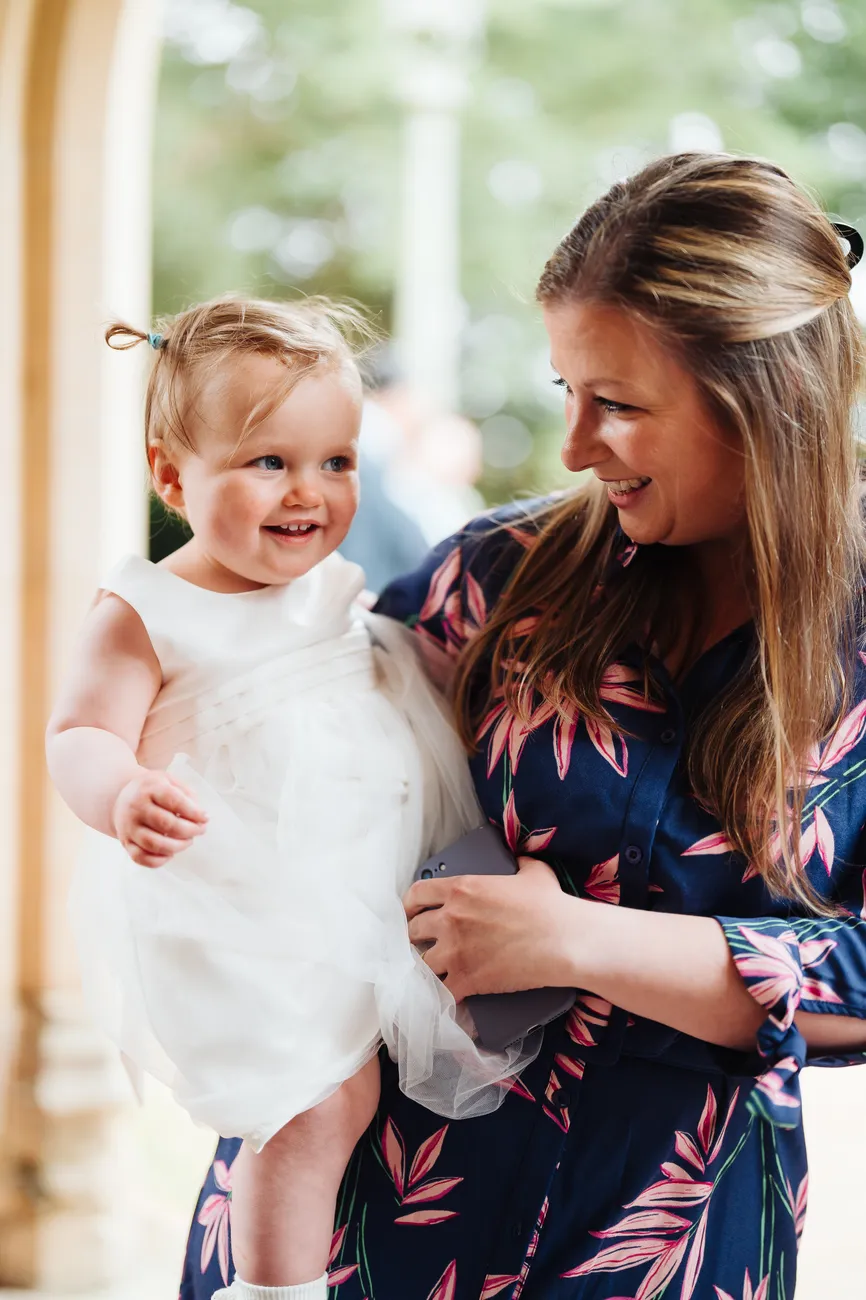 Guests applauding Lucy and George's first kiss at St Andrew's Church Eaton
