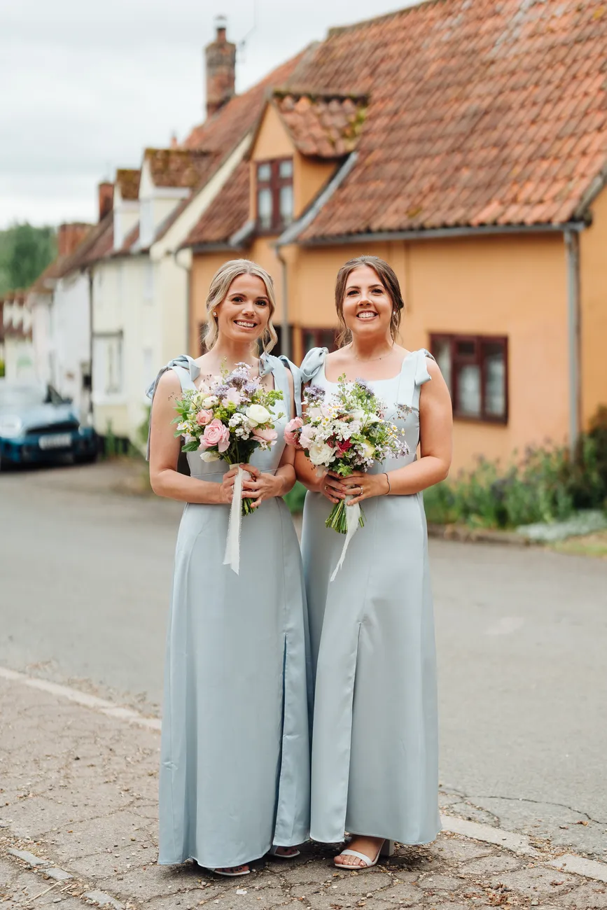 Lucy and George walking back down the aisle as newlyweds at St Andrew's Church
