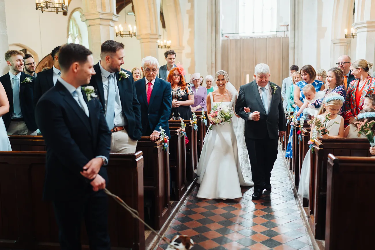 Wide confetti shot outside St Andrew's Church Eaton at Lucy and George's wedding