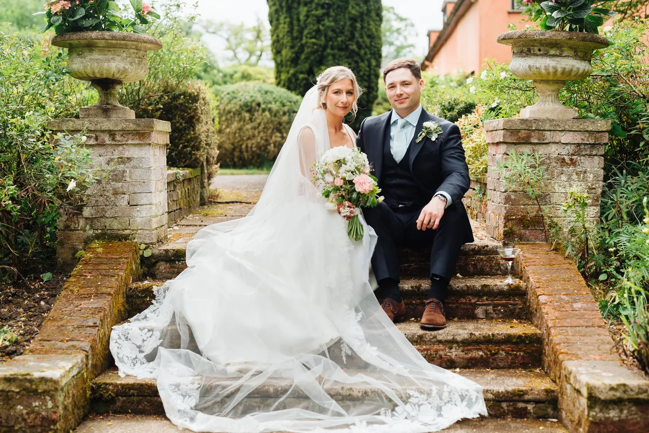 Lucy and George sharing a laugh during the speeches at Preston Priory Barn
