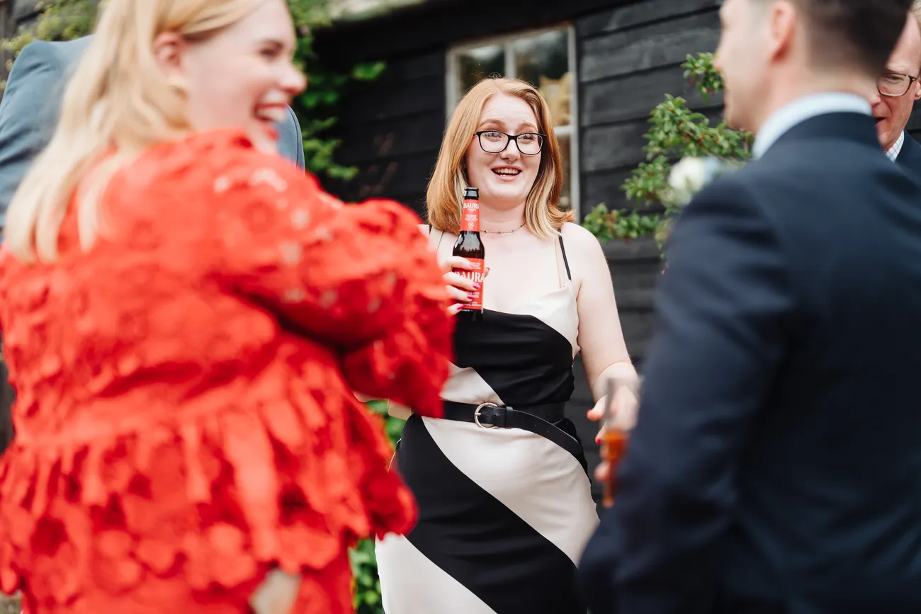 Guests applauding during the wedding speeches at Preston Priory Barn Suffolk