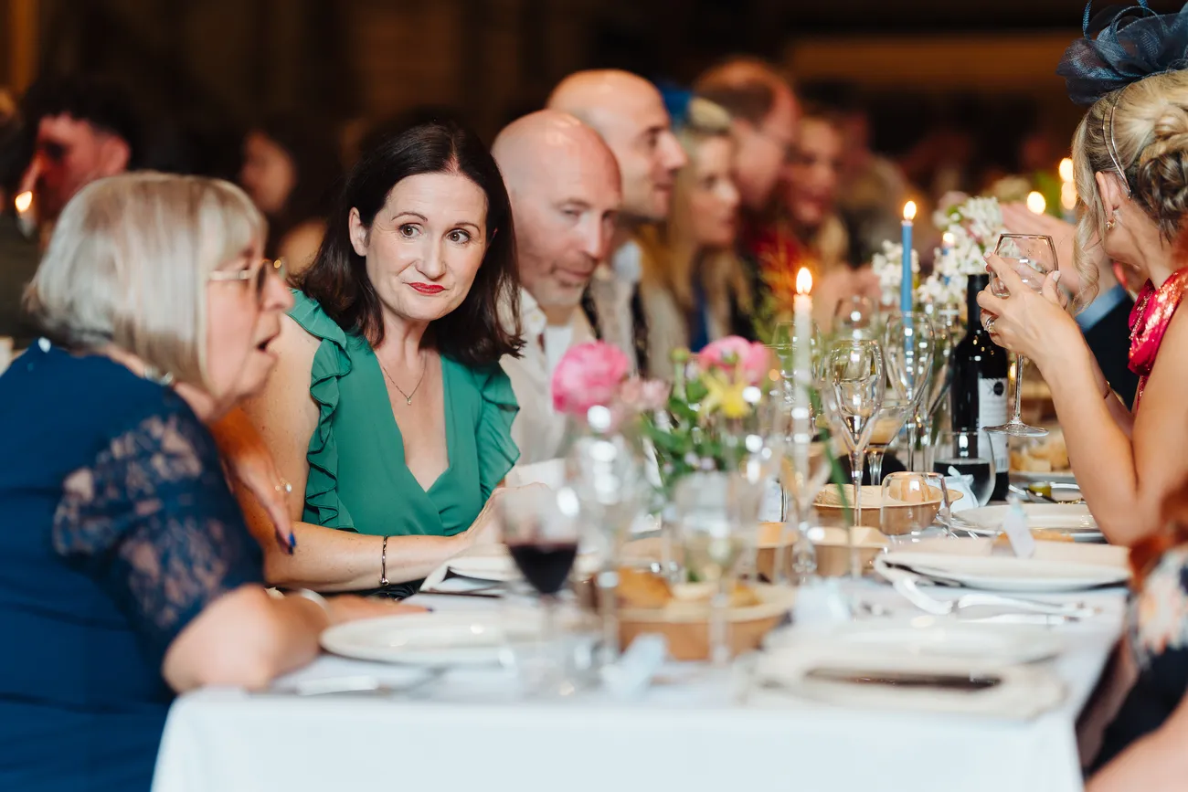 Couple portrait at the wedding table inside Preston Priory Barn Suffolk