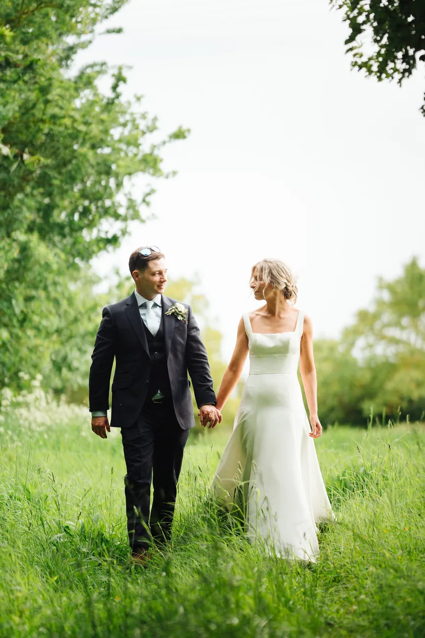 Romantic portrait of newlyweds in the grounds of Preston Priory Barn Suffolk