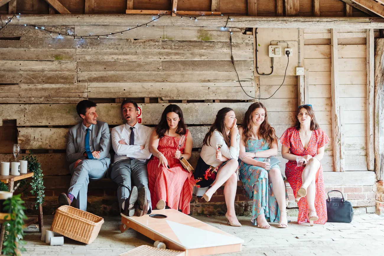 Lucy and George by the historic doors of Preston Priory Barn Suffolk