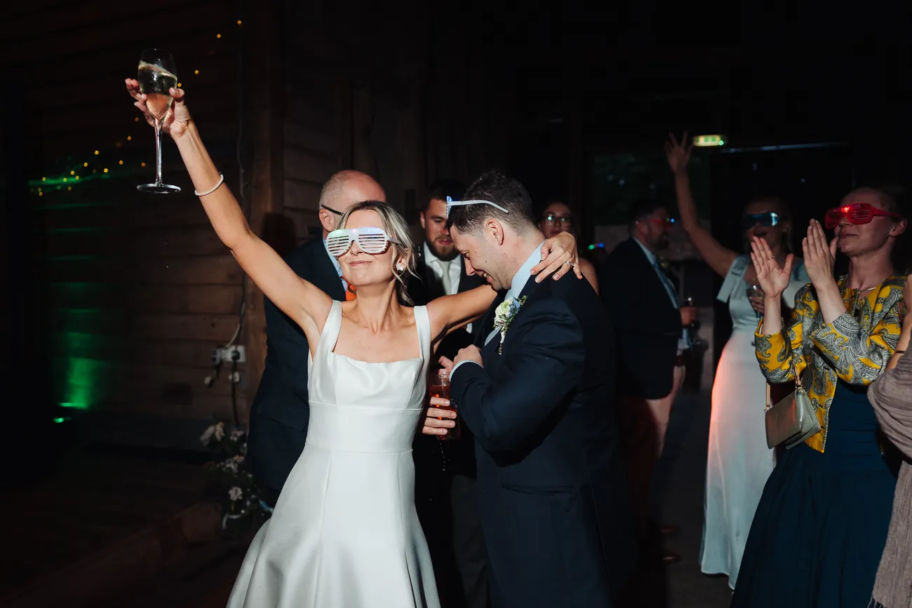 Guests watching Lucy and George's first dance at Preston Priory Barn Suffolk