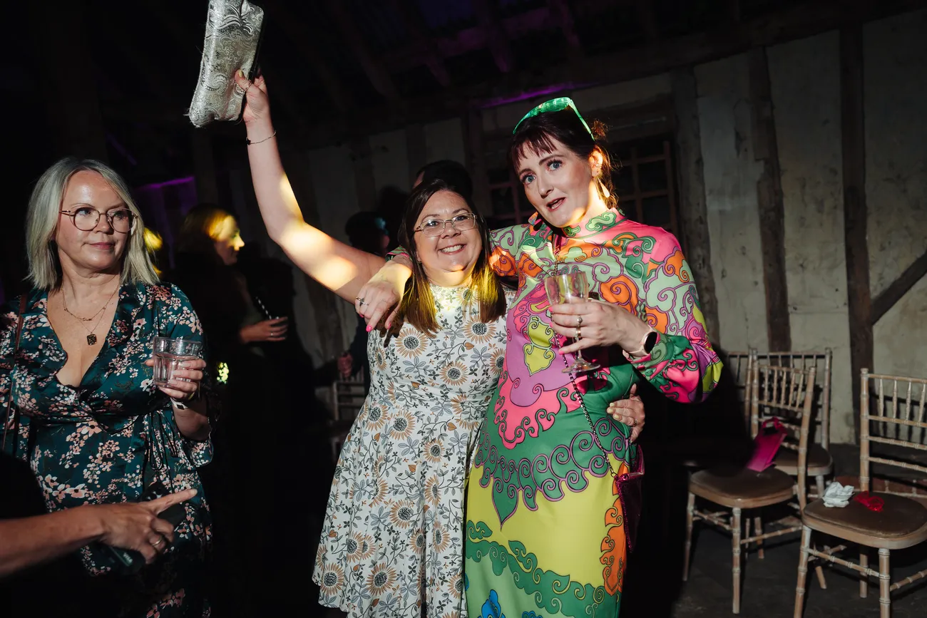 Evening reception party inside Preston Priory Barn Suffolk wedding celebration