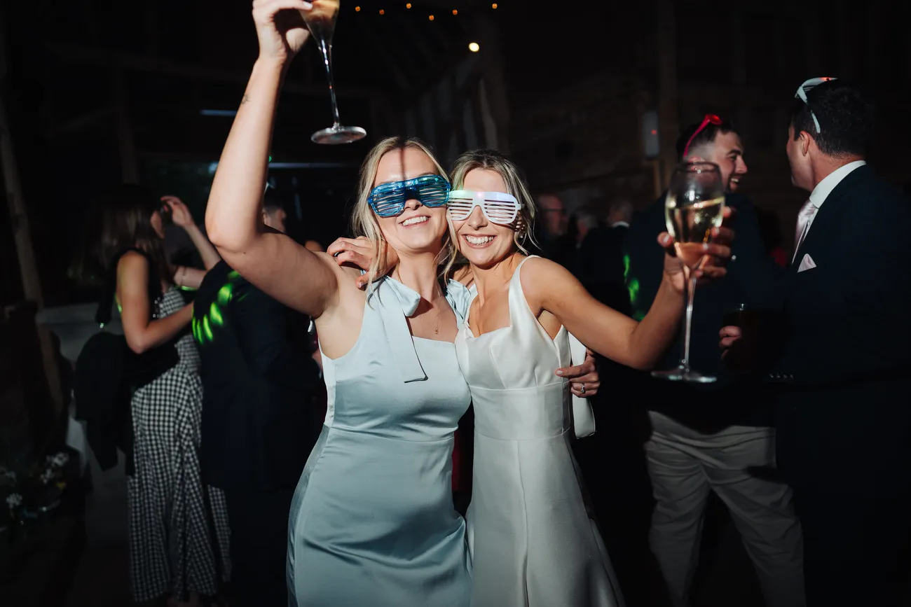 Guests dancing the night away inside Preston Priory Barn Suffolk wedding