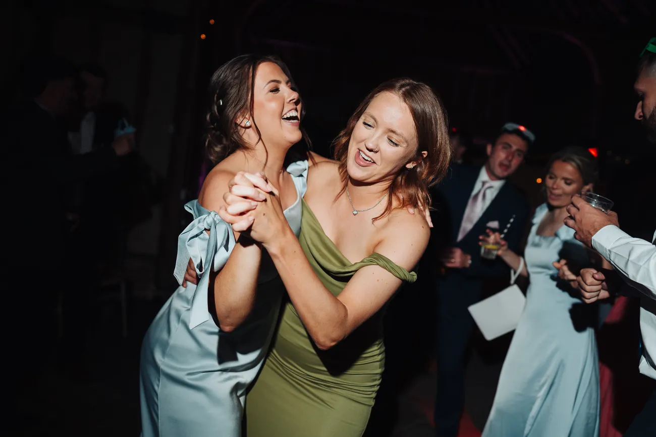 Lucy and George surrounded by dancing guests at Preston Priory Barn