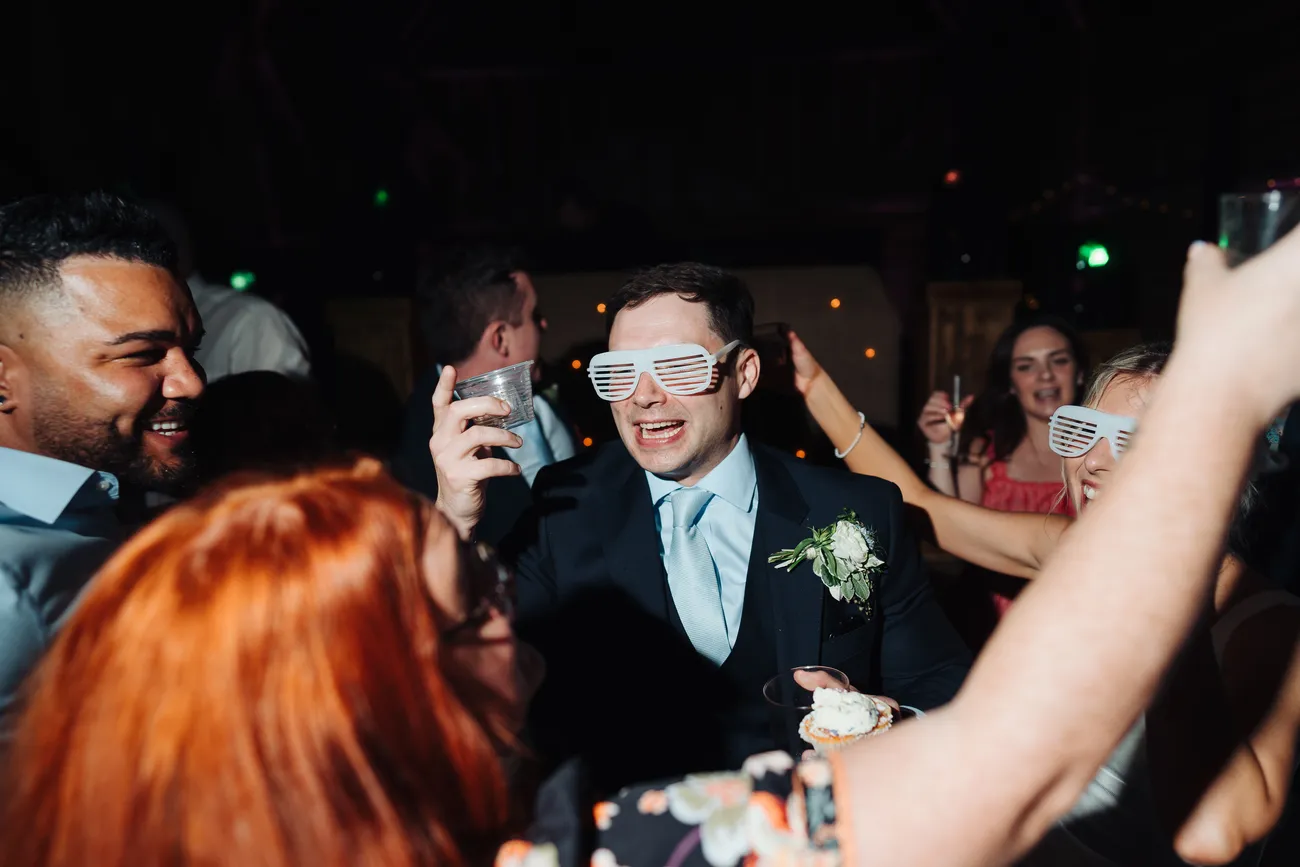 Lucy beaming with joy on the dancefloor at Preston Priory Barn Suffolk