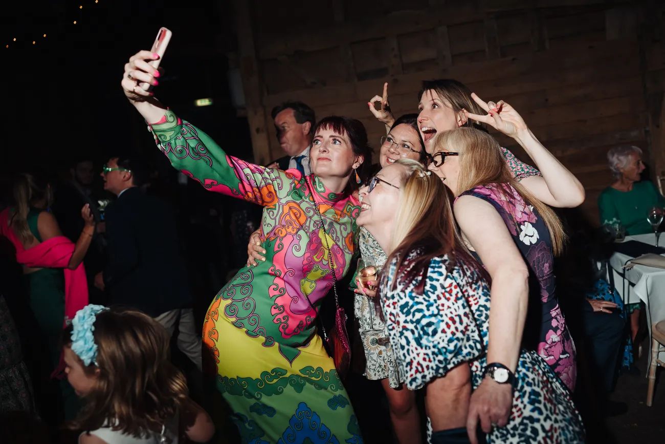 Guests throwing shapes on the dancefloor at Preston Priory Barn Suffolk wedding