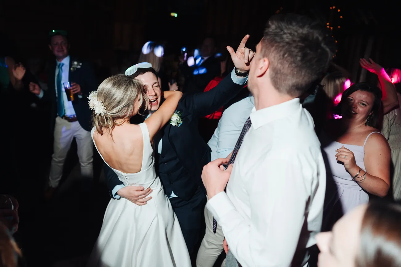 Candid evening reception party photo at Preston Priory Barn Suffolk wedding