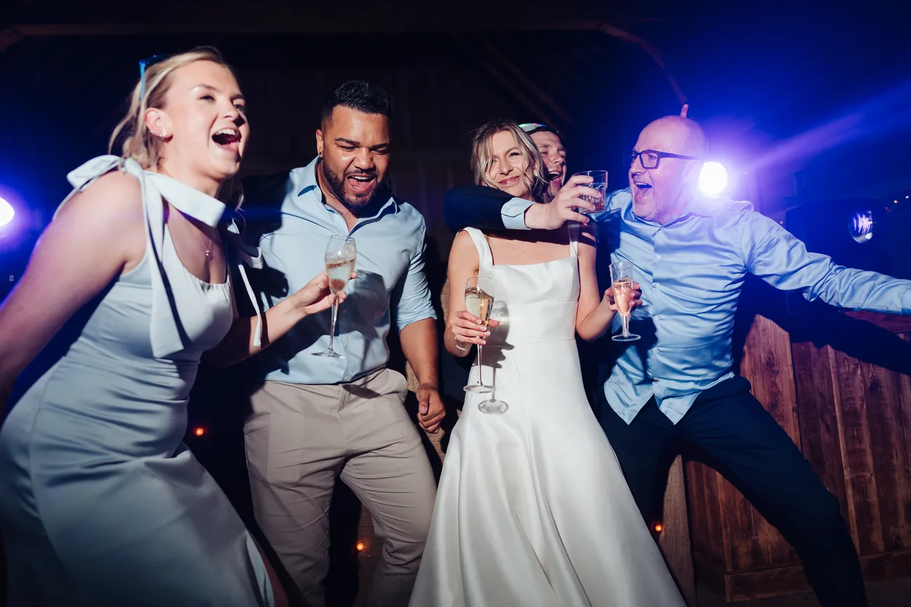 Candid end of evening moment at Lucy and George's Preston Priory Barn wedding