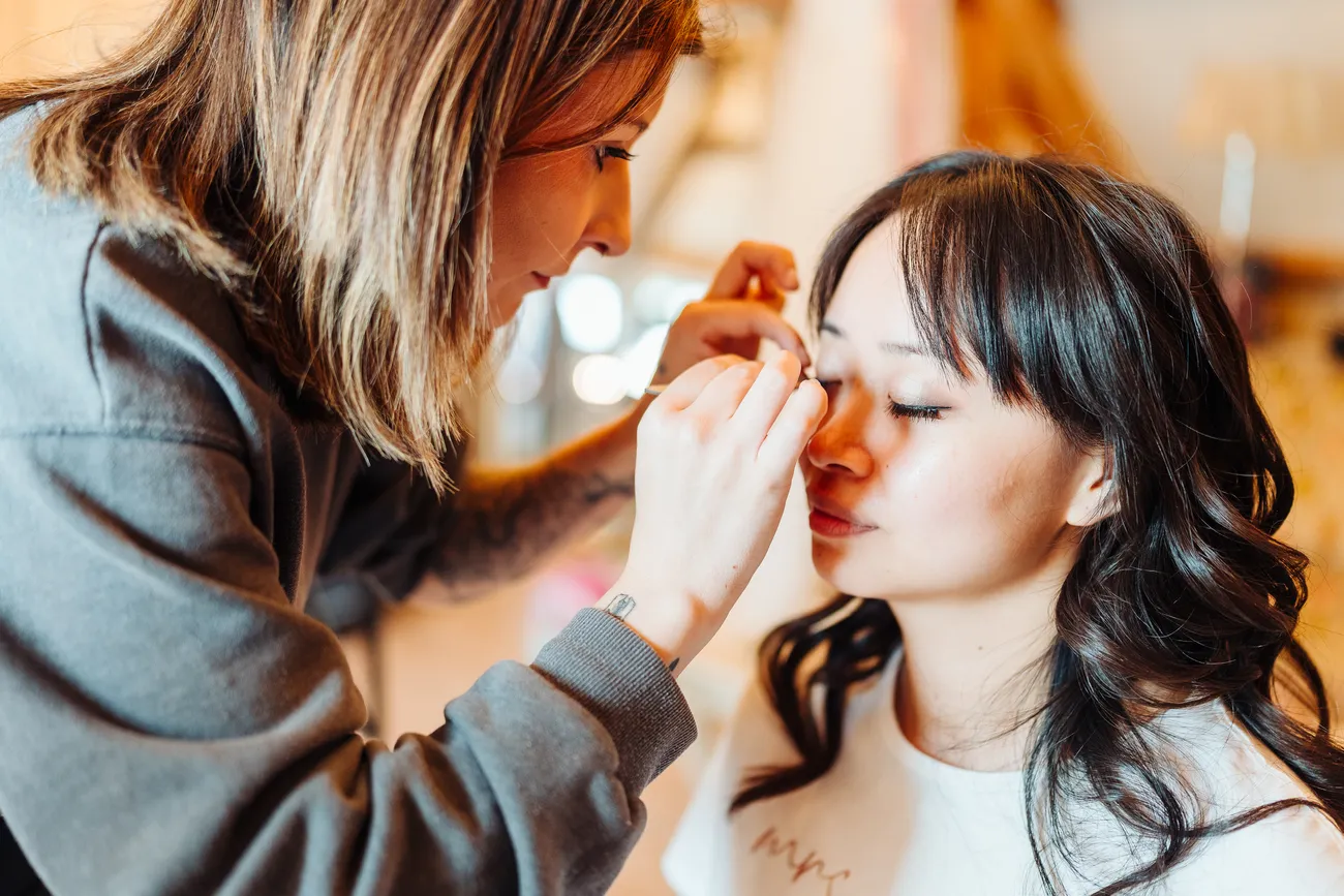Bride getting ready in the preparation suite at Reymerston Hall